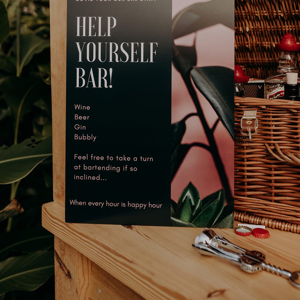 Close up of a sign for the Help Yourself Bar serving wine, beer, gin and bubbly
