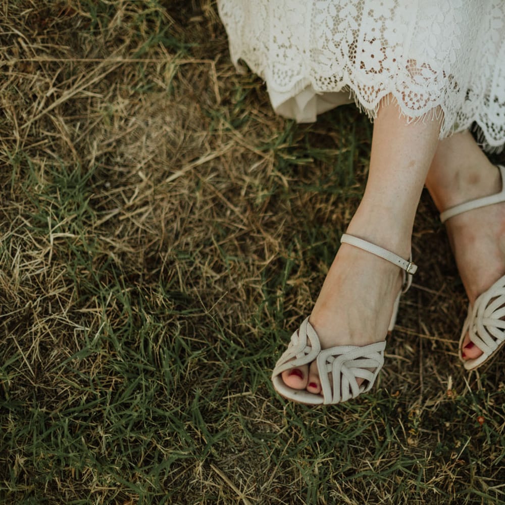 Bridal heels with cutout details paired with a lace wedding dress