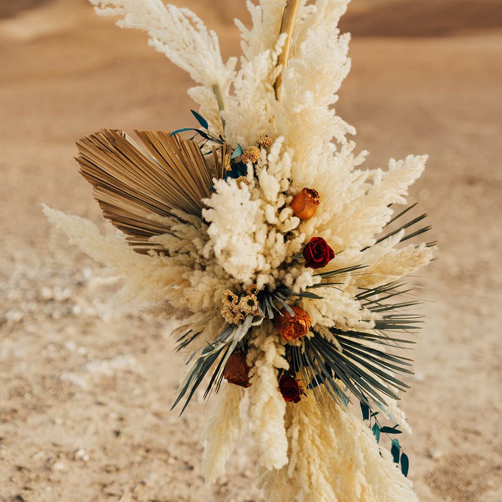 Dried palm leaves and pampas grass on moongate altar decoration 