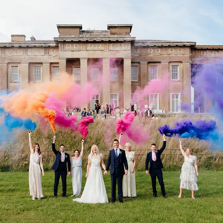 Colourful rainbow smoke bomb photo with the bride and groom and their wedding party 