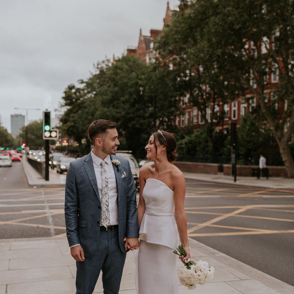Bride in Roland Mouret wedding dress and groom in blue suit