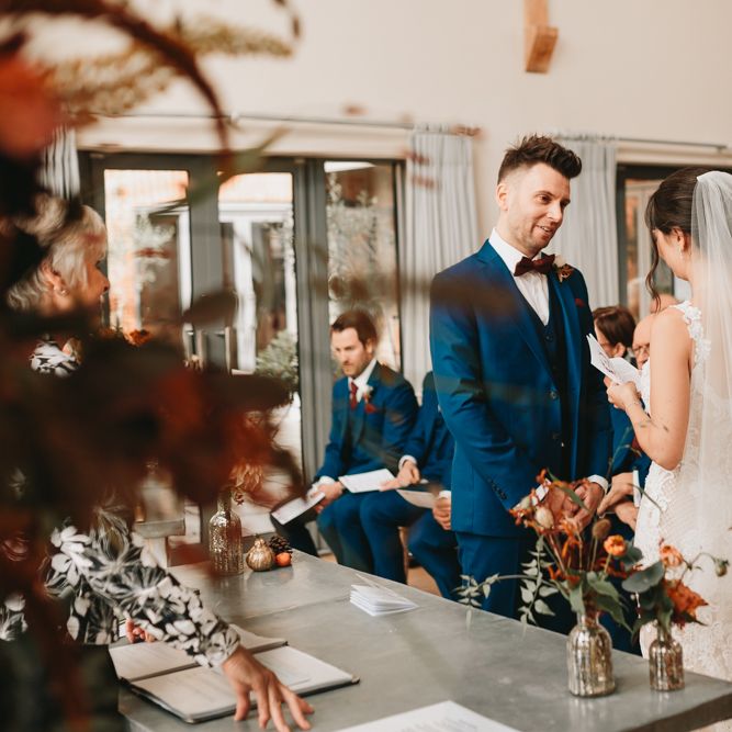 Bride and groom exchanging vows at Millbridge Court wedding