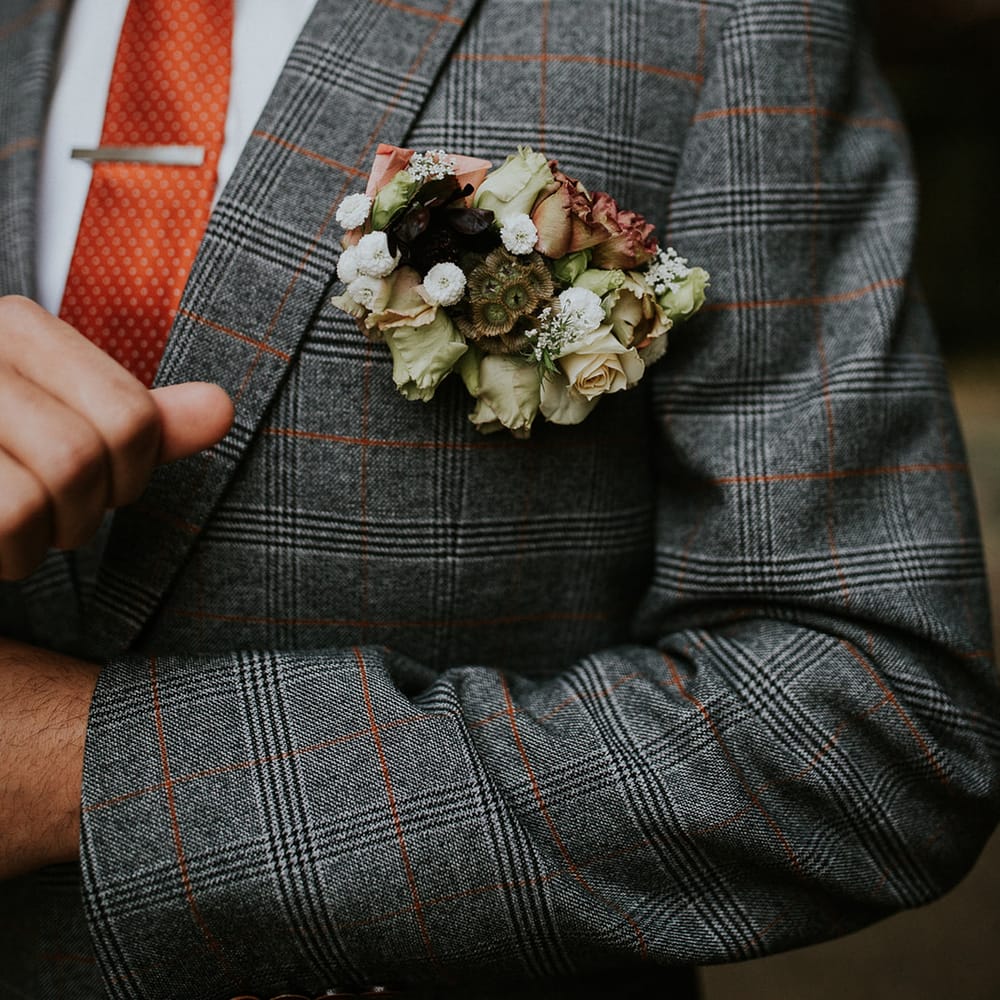 Unique grooms buttonhole with autumn flowers 