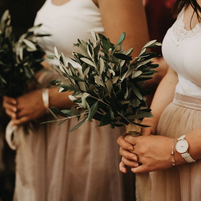 Bridesmaids hold olive bouquets
