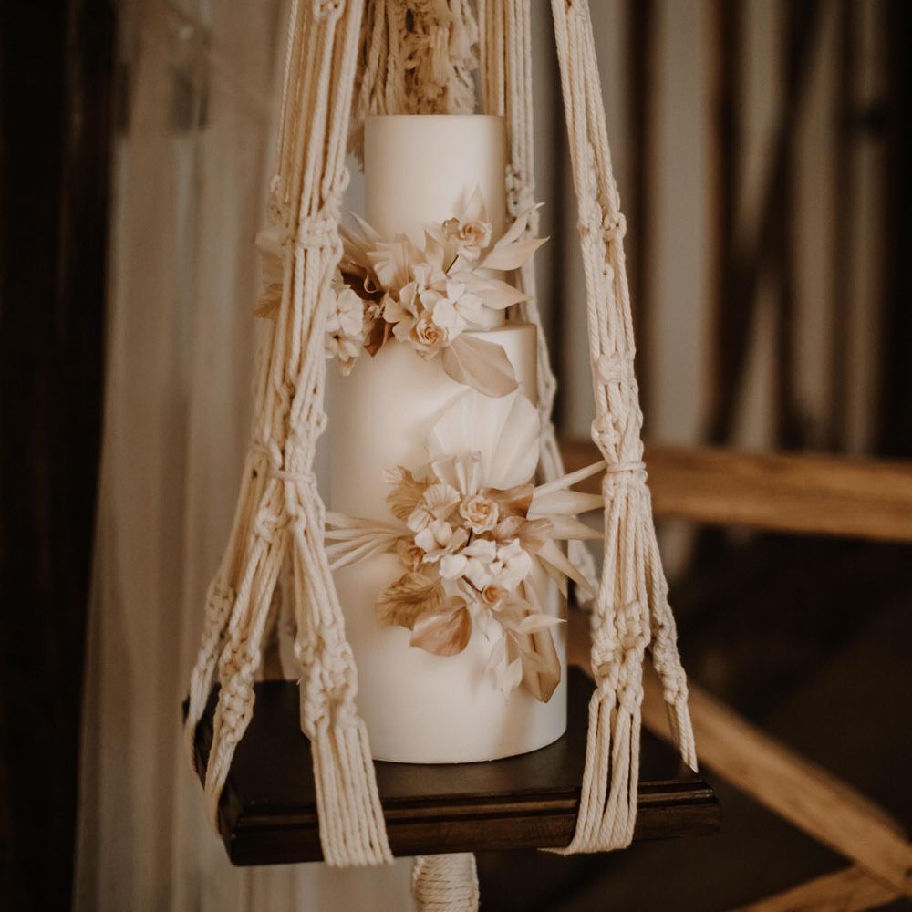 Hanging macrame wedding cake with white rose detail 