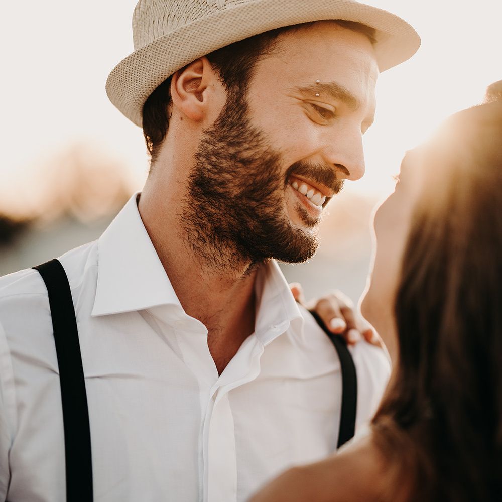 Groom in straw hat for destination wedding