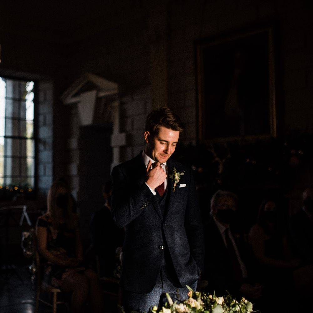 Groom waits for bride during the wedding ceremony