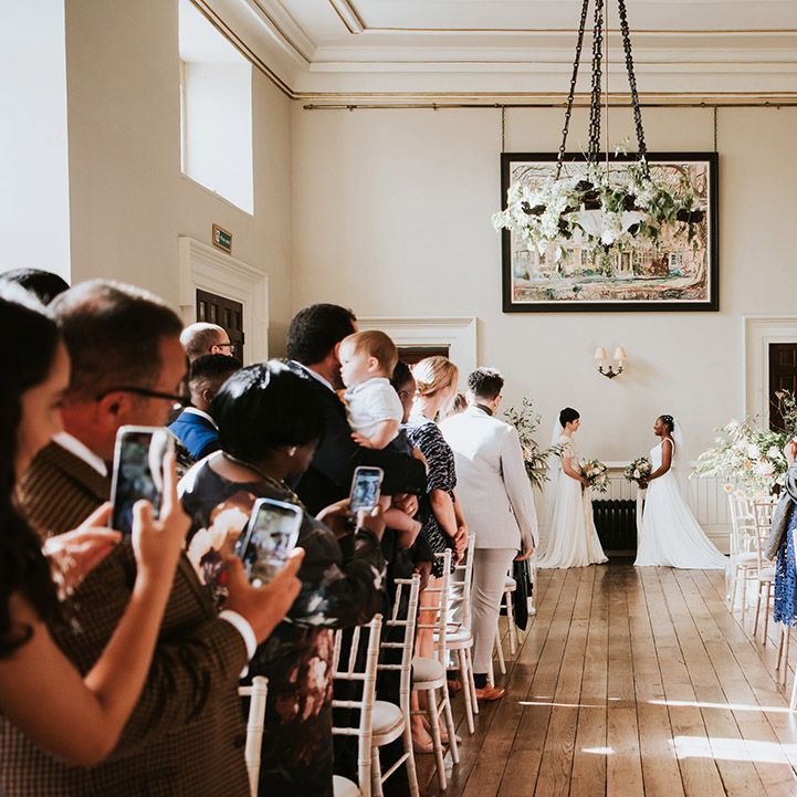 Two brides exchanging personalised vows at their civil wedding ceremony 