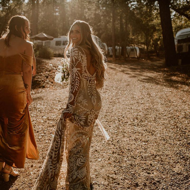 Bride walks with bridesmaid on her wedding day