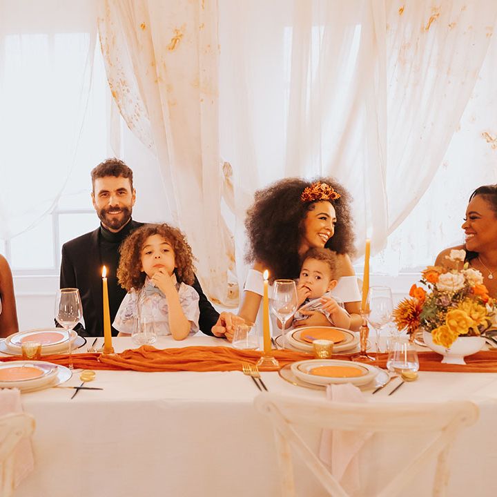 Family wedding with page boys sat on the bride and grooms lap with draping behind the top table