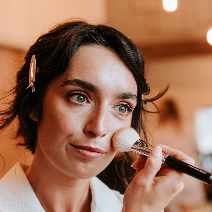 Bride gets makeup done for her wedding day