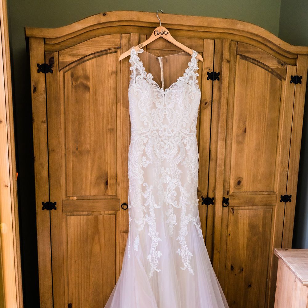 Lace wedding dress with mermaid tulle skirt on hanger 
