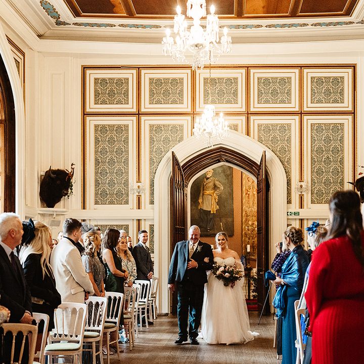 Drumtochty Castle wedding venue with crystal chandelier and grand double doors where bride and father of the bride make their entrance