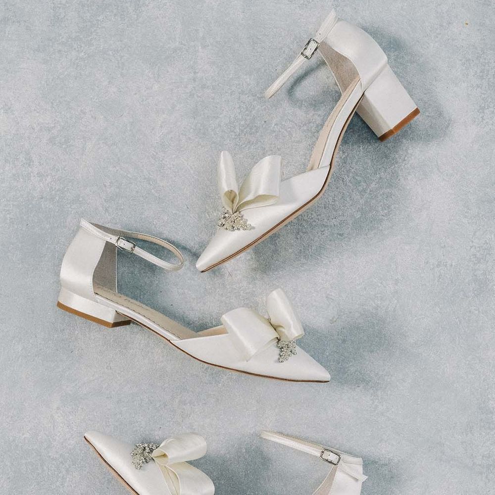 White wedding shoes with bow and crystal embellishment in flats, stiletto and short square block heel styles