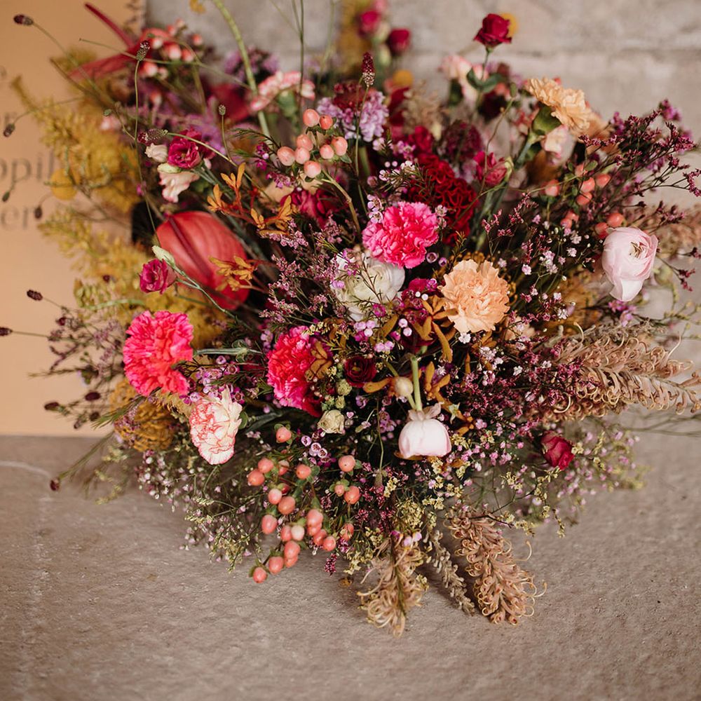 wildflower wedding arrangement with carnations, anthuriums and grasses