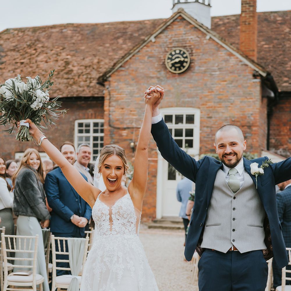 Bride and groom celebrate as they walk back down the aisle as a married couple