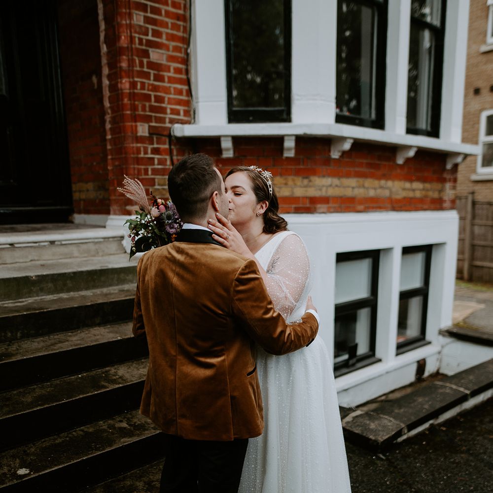 The couple share a kiss at home before attending their London wedding ceremony