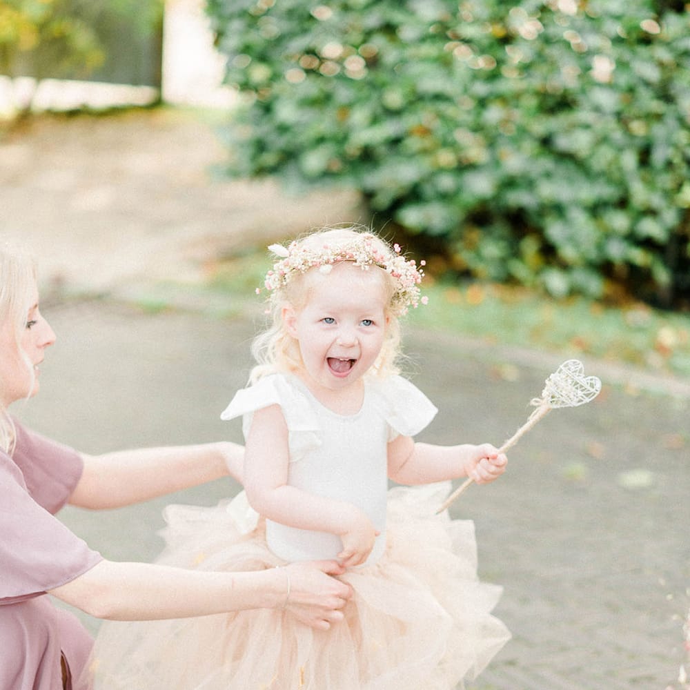 Flower girl wears pastel peach tutu and white Dr Martens with pink silk ribbon laces