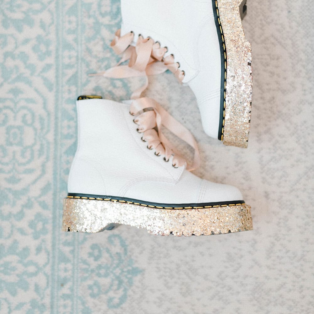 White Dr Martens finished with pink ribbon laces and sparkly heels 
