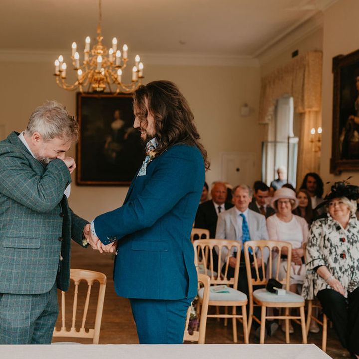 Grooms laugh during wedding speeches at the Cambridge Cottage for Kew Gardens wedding 