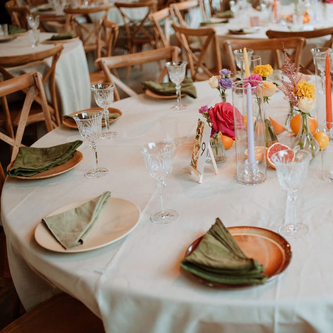 colourful wildflowers, taper candles and fruit centrepiece decoration