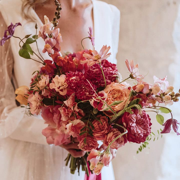 Dark and light pink wedding bouquet with roses, sweet pea and more for the pink theme rustic wedding 