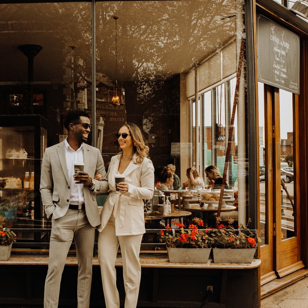 Bride and groom enjoying coffee outside their favourite cafe after their city elopement 