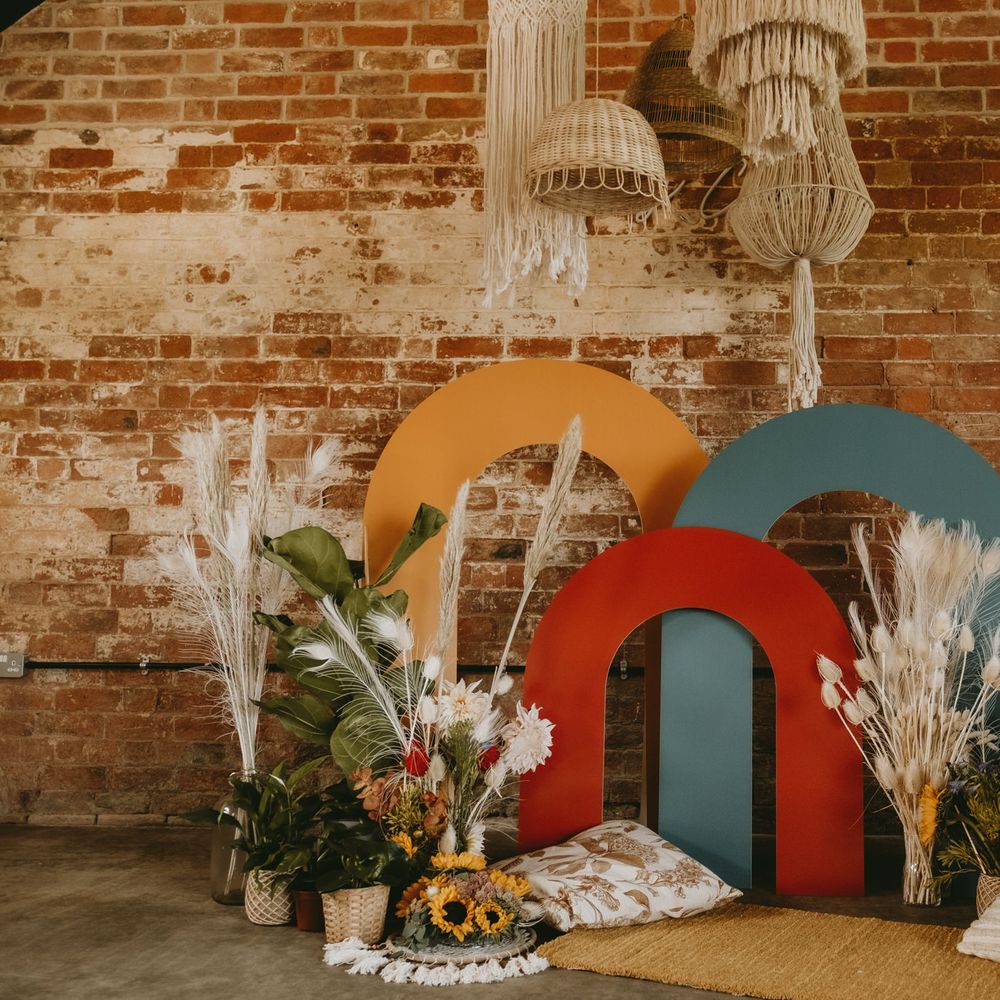Chill out area with cushions, colourful structured altar and dried flowers 