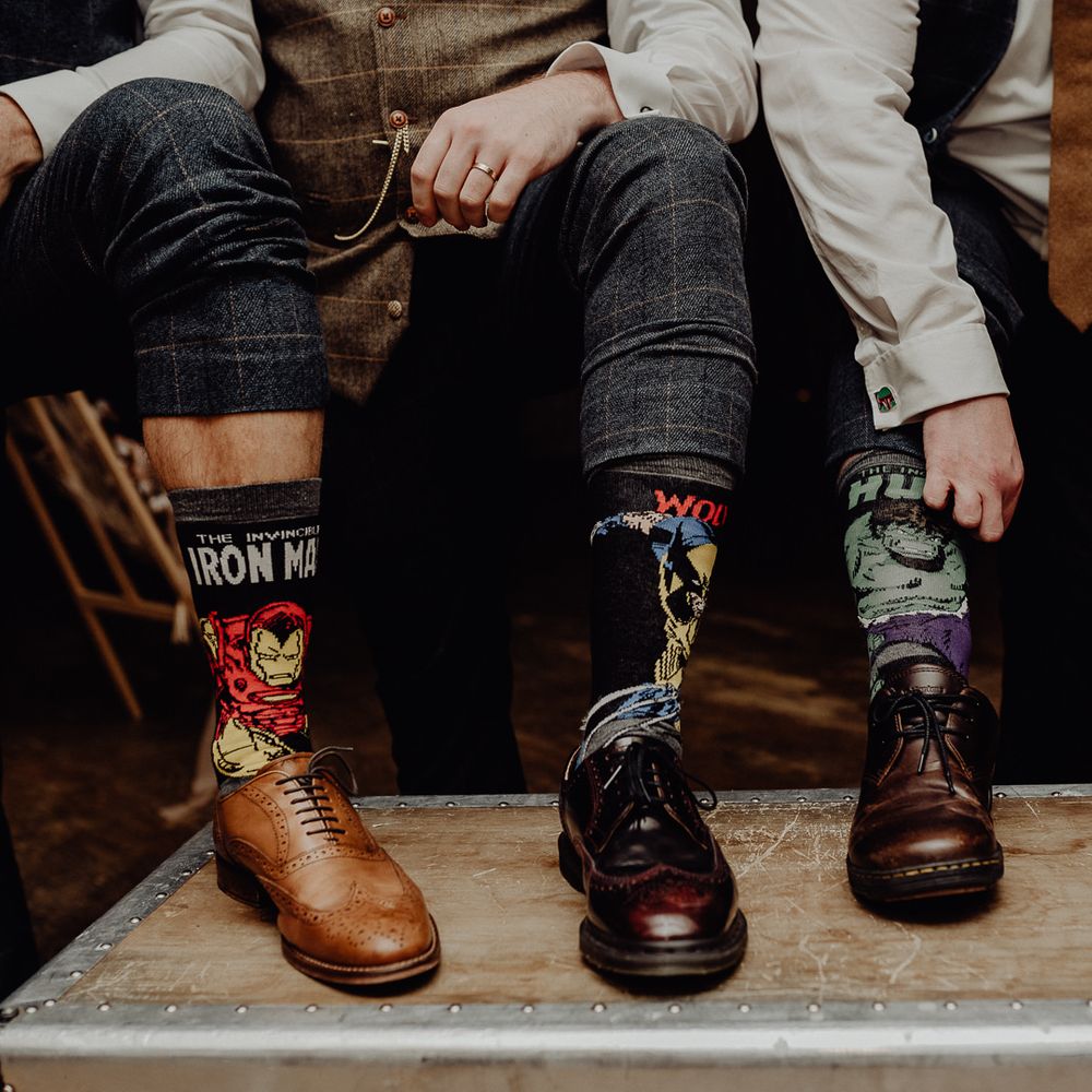 Groomsmen wearing Marvel superhero socks