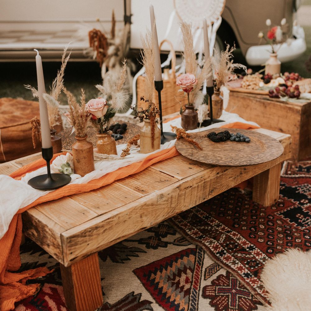 Low wooden table complete with black candlestick holders 