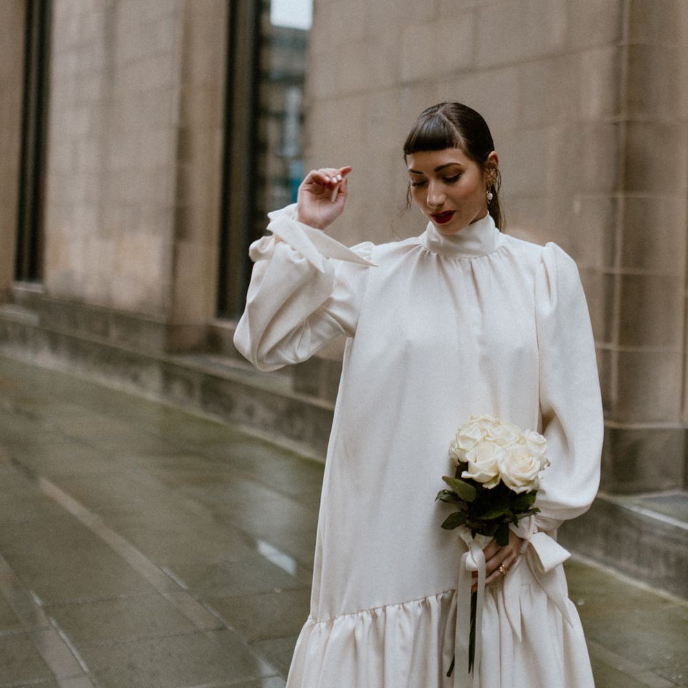 High neck silk wedding dress with long sleeves and ruffled hem