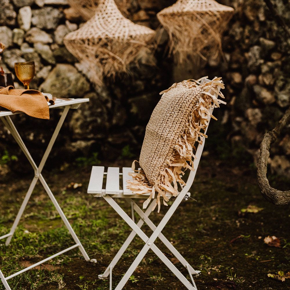 White wooden chair with heavy woven pillow