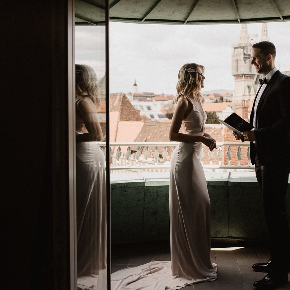 Bride and groom reading their vows on the balcony at Amadria Park Hotel in Croatia