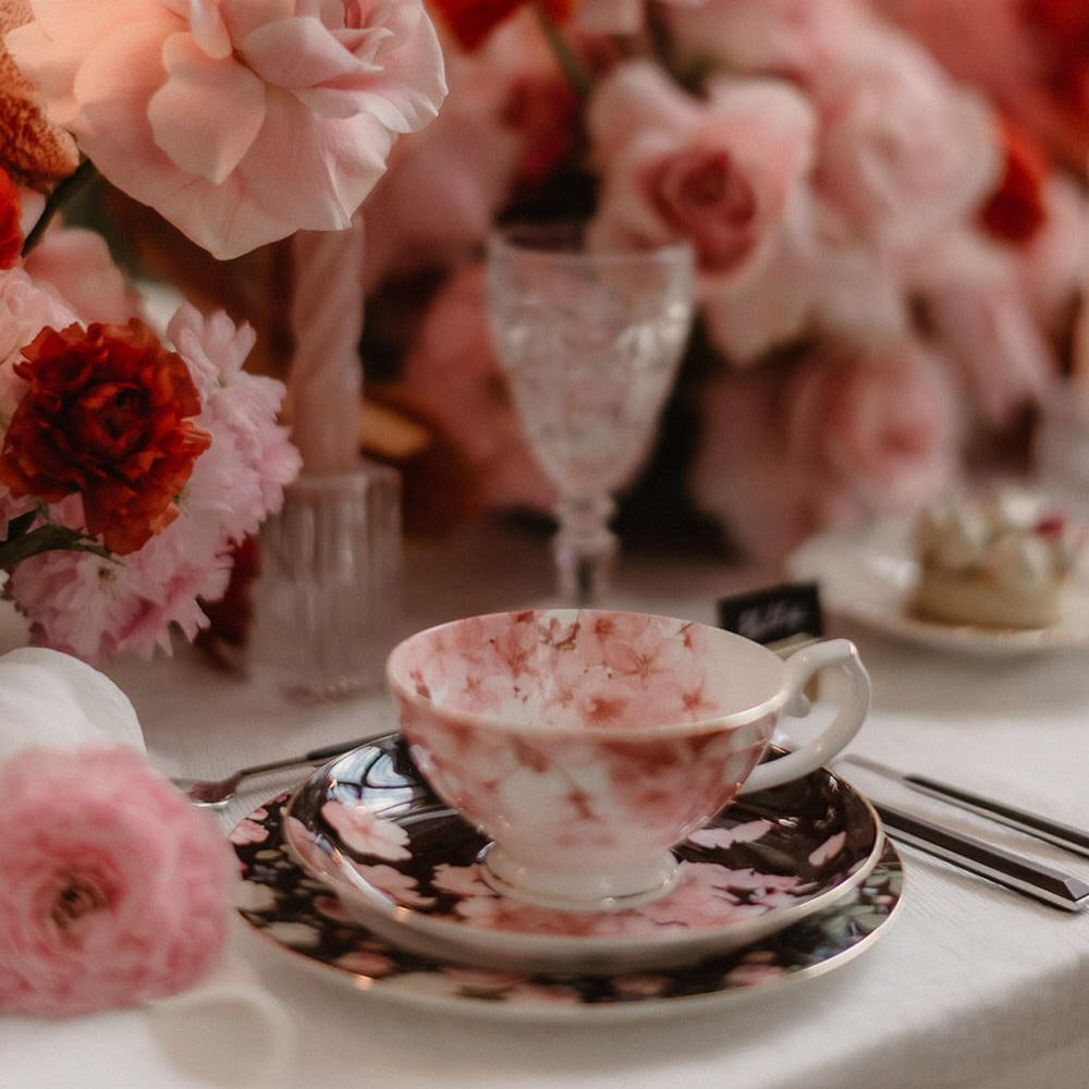 Pink wedding flowers with blossom patterned wedding teacup and saucer