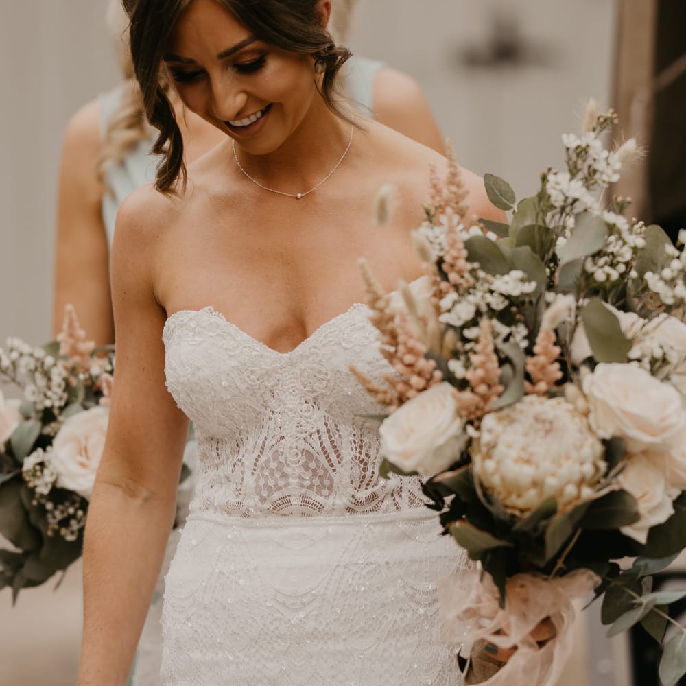 Bride wears Enzoani wedding gown whilst carrying white floral bouquet complete with greenery | Mark Bamforth Photography