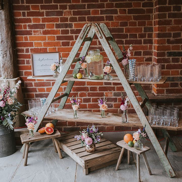 Hydration station made from rustic wooden ladders to keep guests refreshed in hot summer weather 