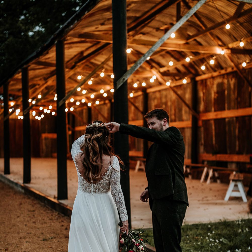Groom in green wool suit spins bride around wearing illusion lace long sleeve wedding dress 