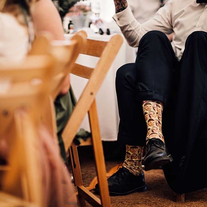 Groomsmen with personalised socks of the bride and groom's faces 