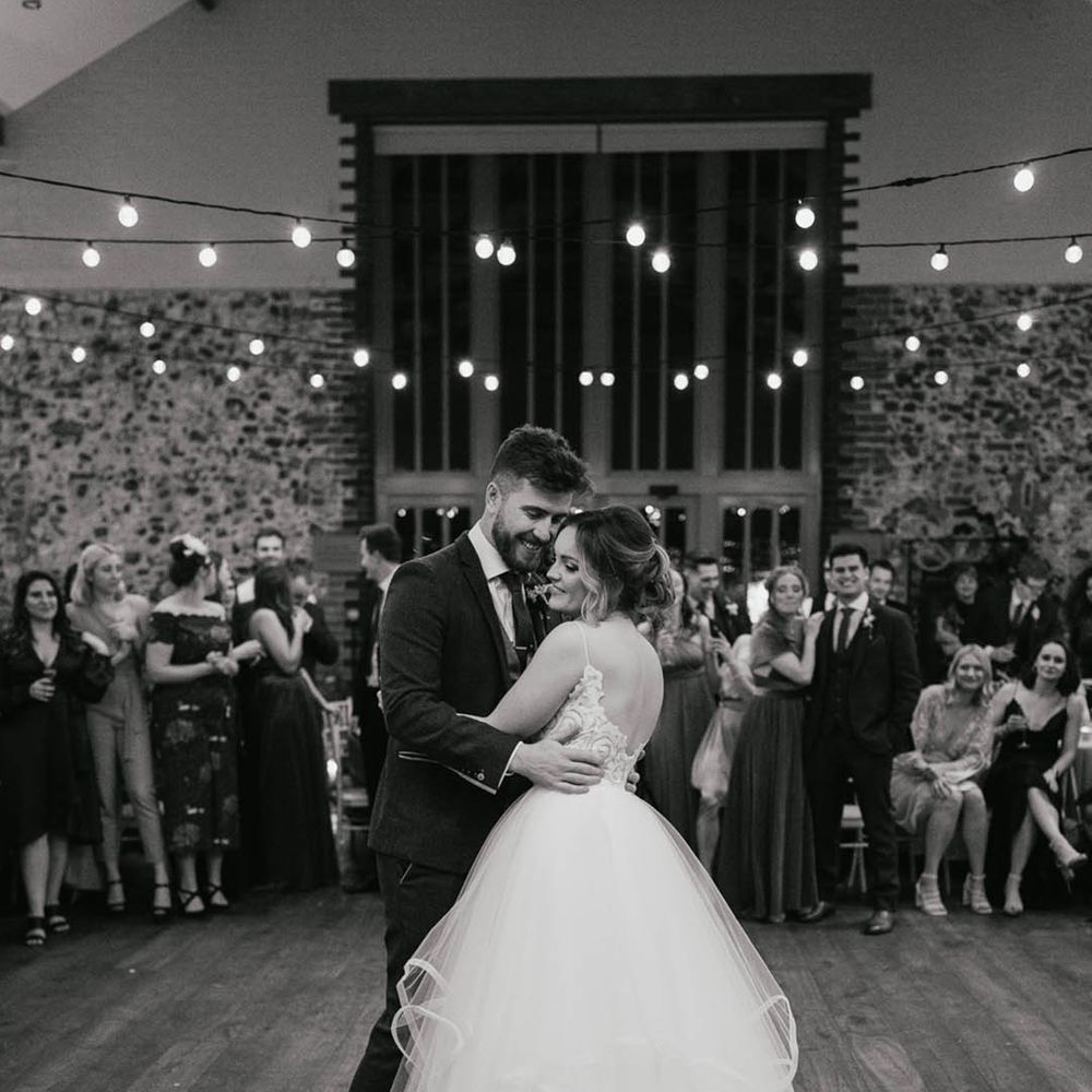 Bride in tulle princess skirt Blush by Hayley Paige wedding dress has her first dance with the groom 