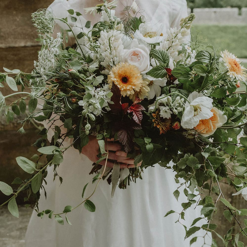 Oversized wedding bouquet with foliage and yellow and white flowers 