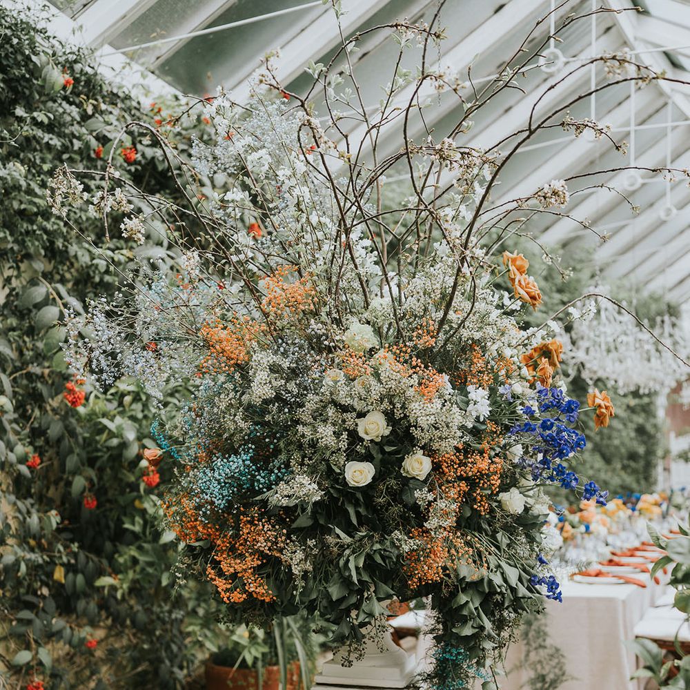 Large extra flower arrangement with blue, orange and white flowers