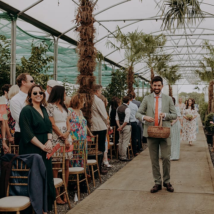 Bridal party walk down aisle scattering flowers