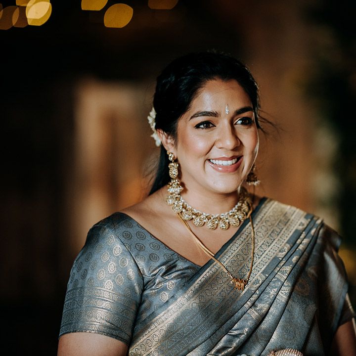 Wedding guest wears silk gold and silver outfit for Hindu & Punjabi wedding at British barn