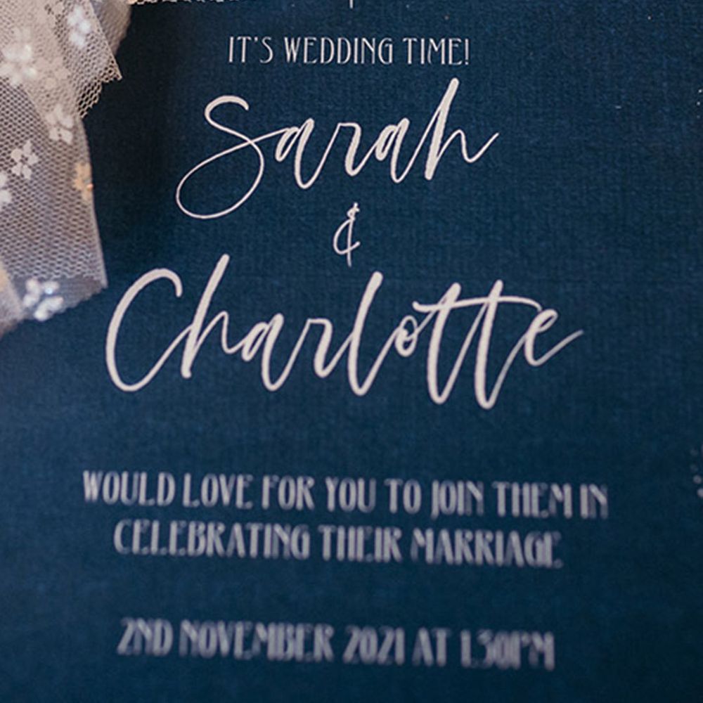 Midnight blue wedding invitation with whit calligraphy and star illustrations 