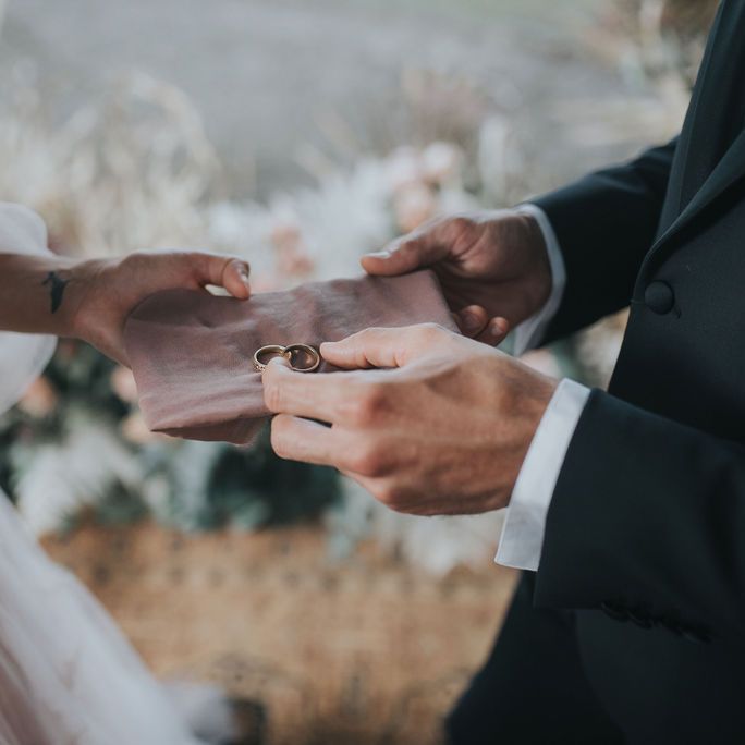 wedding rings on a pink handkerchief at Tuscany Elopement 