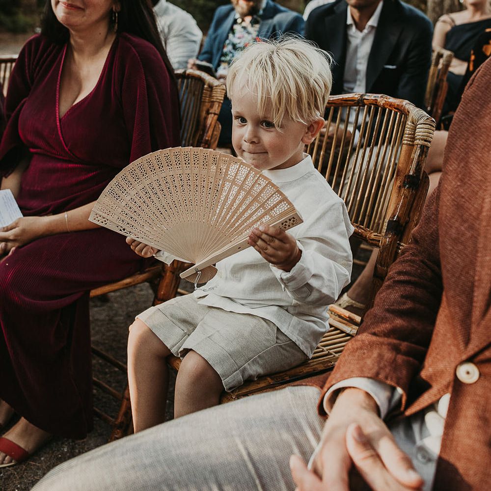 Page boy with wooden fan favour for Andalusia wedding