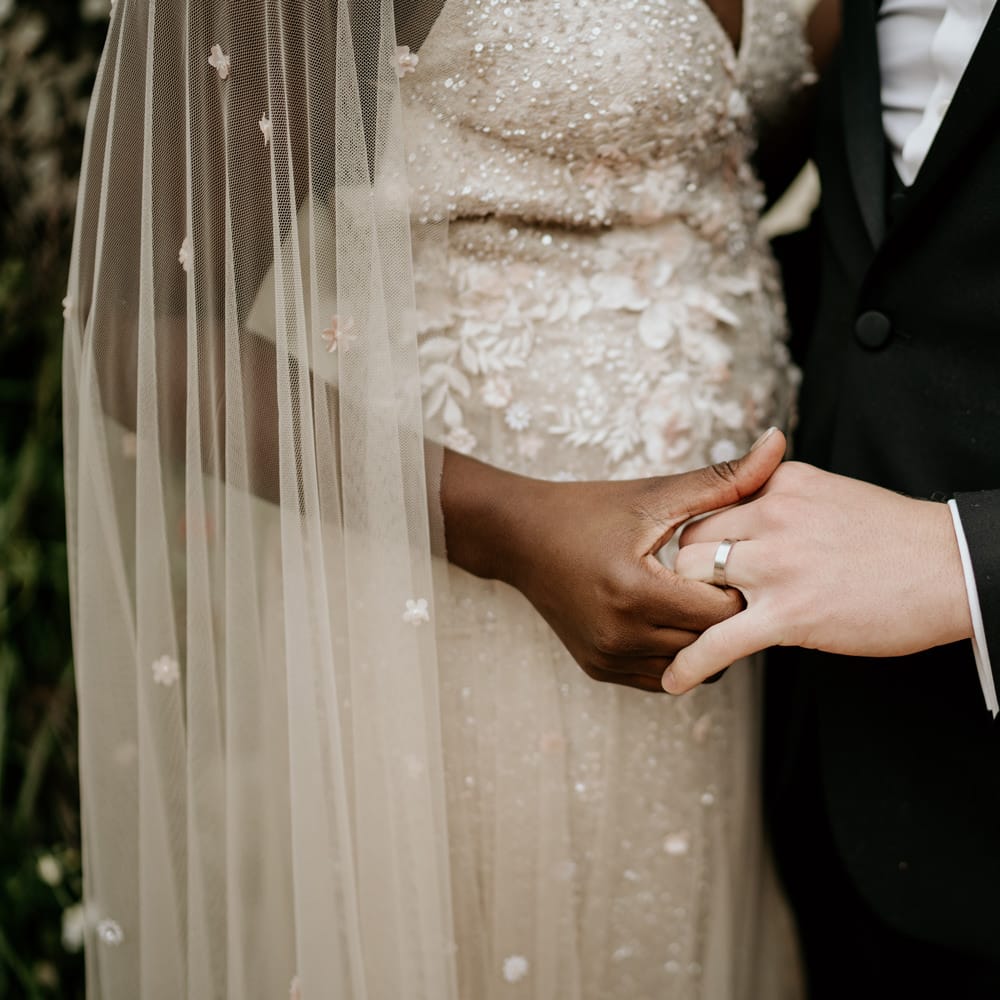 Black bride and white groom holding hands at intimate elopement 