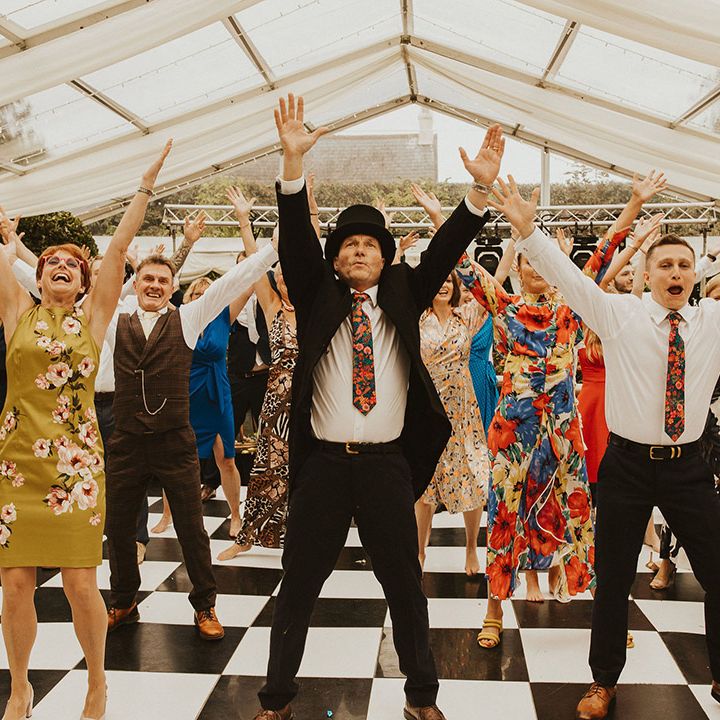 Surprise flash mob dance in a clear marquee at back garden wedding 