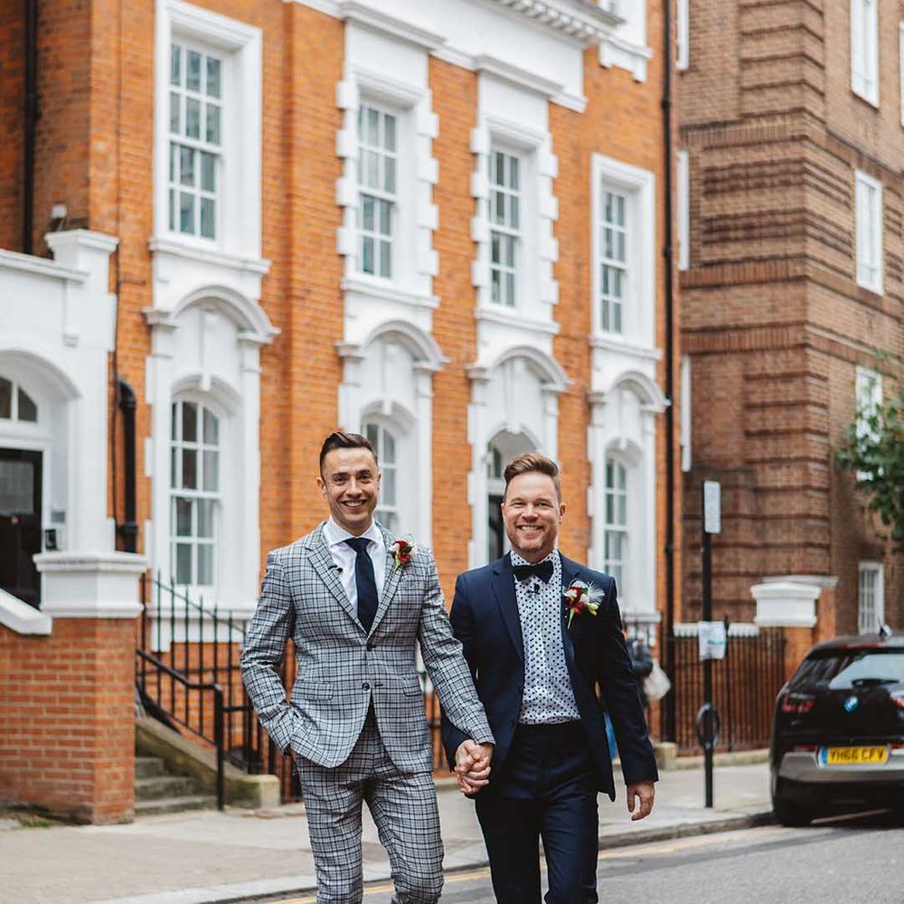 Grooms walks through Chelsea on their wedding day 