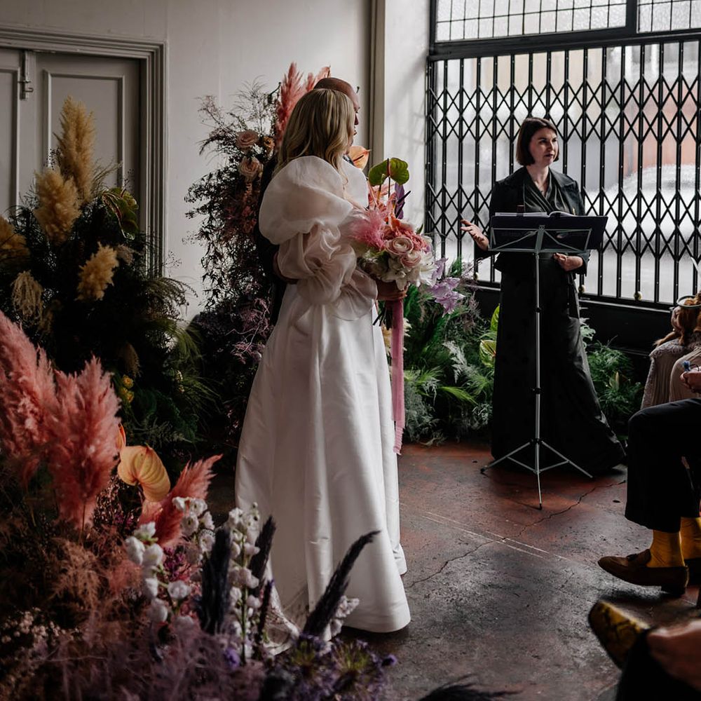 Humanist wedding ceremony at Floral Hall with column flowers decorating the altar 
